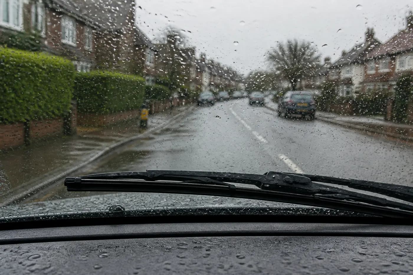 Close-up of a windscreen wiper blade on wet glass