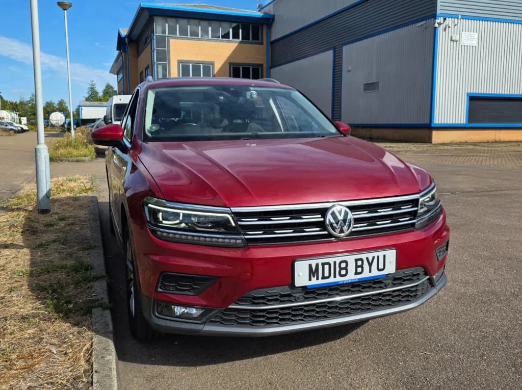 Red 2018 VW Tiguan MK2 owner car (MD18 BYU) parked by an industrial building — authentic community owner photo